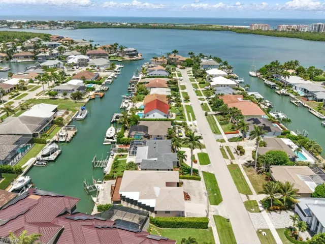 Aerial perspective of home on direct water canal close to Collier Bay, Esplanade, River and Gulf
