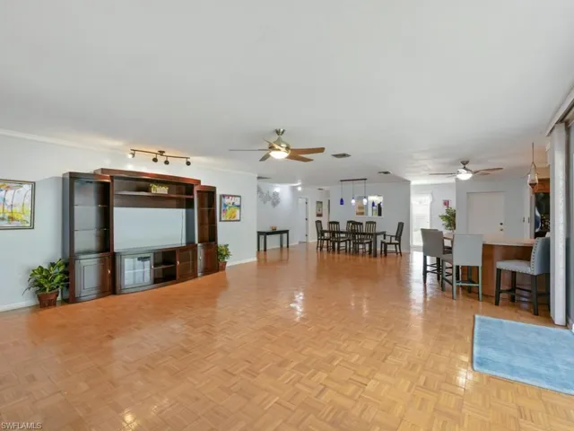 Living room with ceiling fan and baseboards