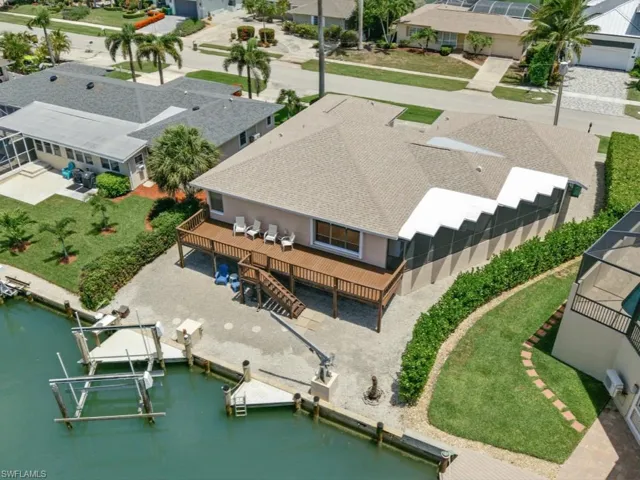 Aerial view of home and 12,000 lb boat lift on direct water canal
