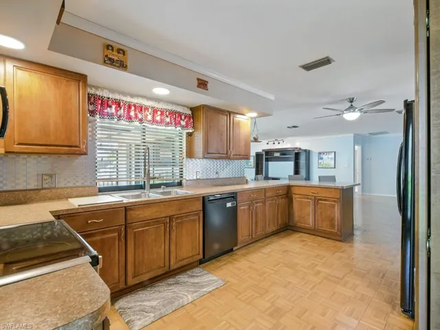 Extra large Kitchen featuring newer appliances, a peninsula, tasteful backsplash, modern cabinets, and crown molding