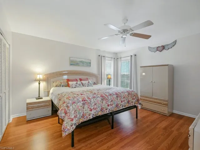 Primary Bedroom featuring light wood-style floors, double closets, and ceiling fan