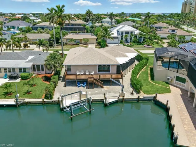 Aerial perspective of suburban area featuring a large body of water