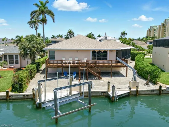 Back of house with 12,000 lb boat lift, southwest exposure and direct water to Gulf