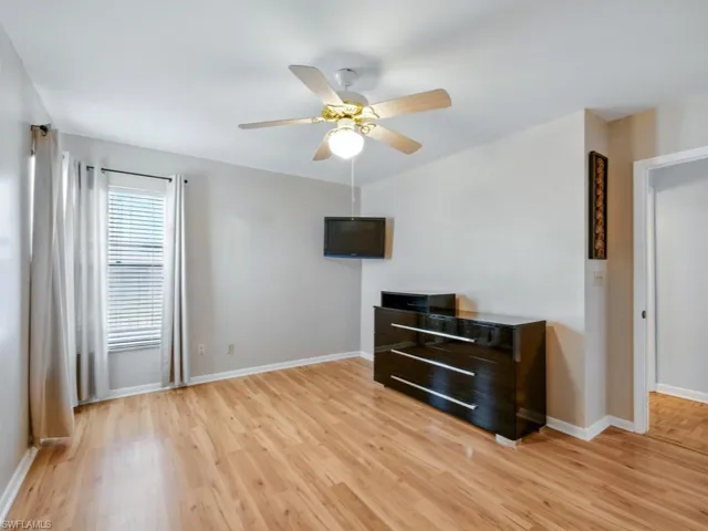 Guest bedroom with fan and double closets