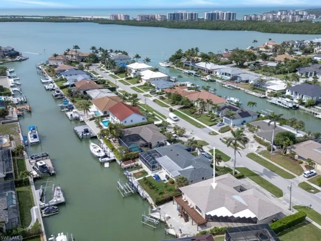 View of property location featuring a nearby body of water and nearby suburban area