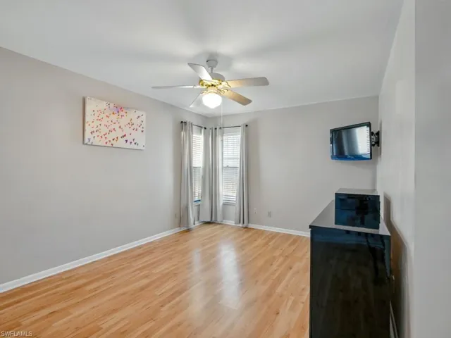 Guest room featuring a ceiling fan and light wood finished floors