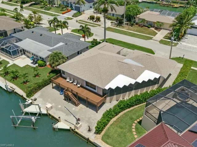 Aerial perspective of suburban area featuring a large body of water