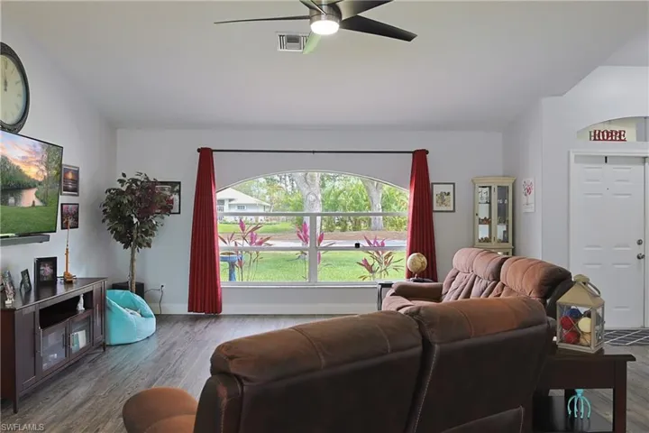 Living room with a ceiling fan and wood finished floors