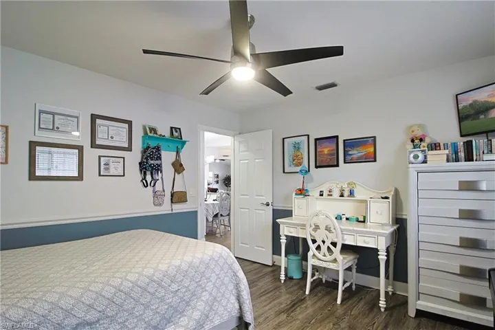 Bedroom with dark wood-style floors and ceiling fan