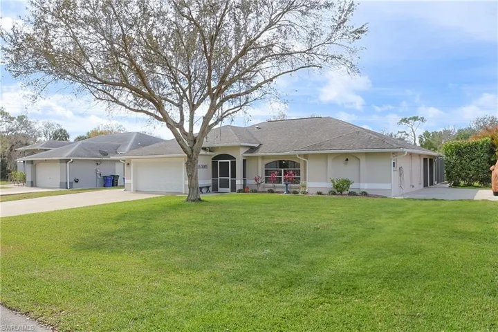 Single story home featuring a front lawn, concrete driveway, a garage, stucco siding, and a shingled roof