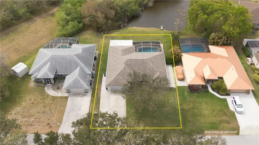 Aerial overview of property's location featuring property parcel outlined and a large body of water
