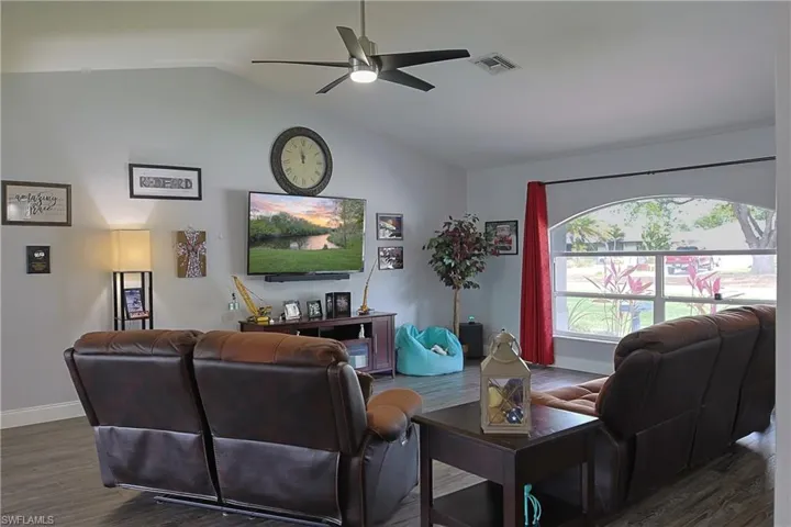 Living area featuring wood finished floors and ceiling fan