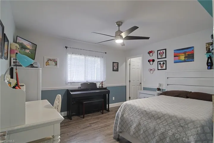 Bedroom featuring wood finished floors and a ceiling fan