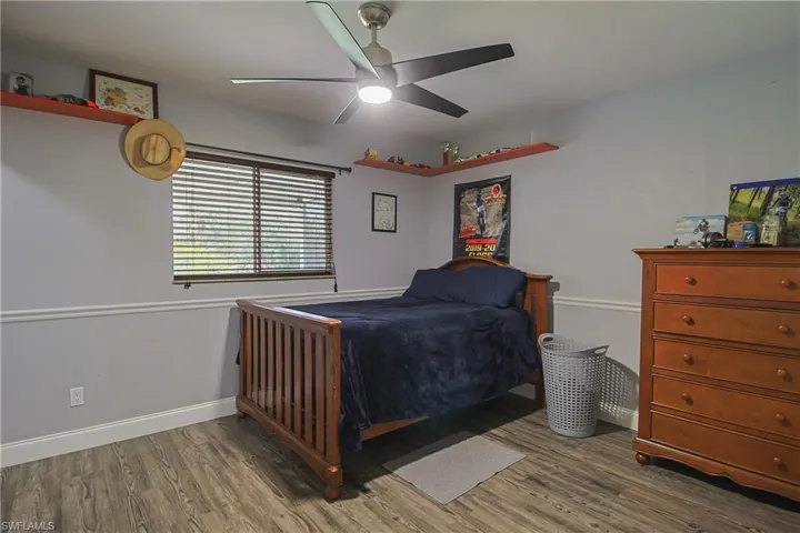 Bedroom featuring wood finished floors and a ceiling fan