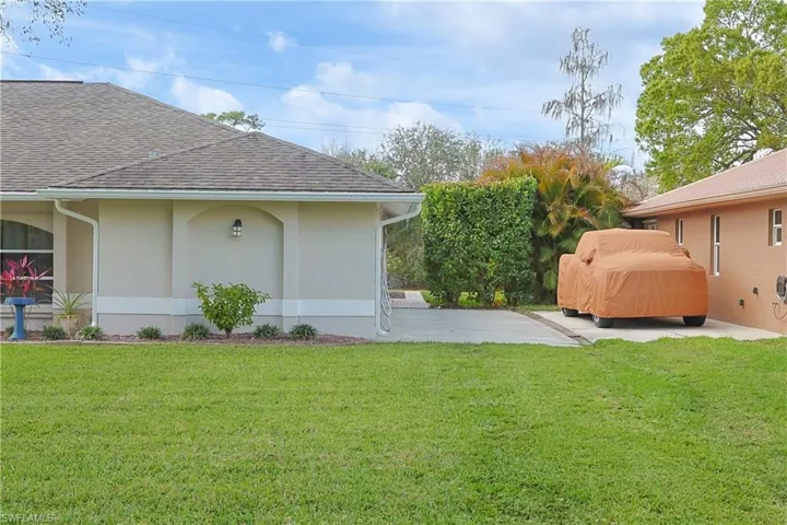 View of grassy yard with a patio area