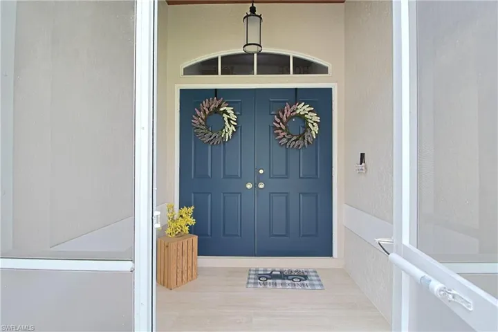 Entrance to property with stucco siding