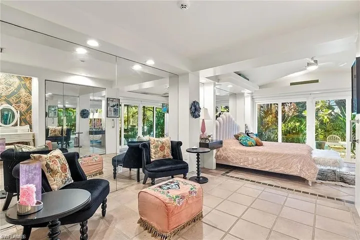 Bedroom featuring light tile patterned flooring, access to outside, multiple windows, and recessed lighting