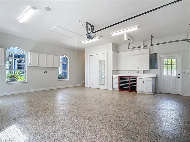 Garage with electric panel and a garage door opener
