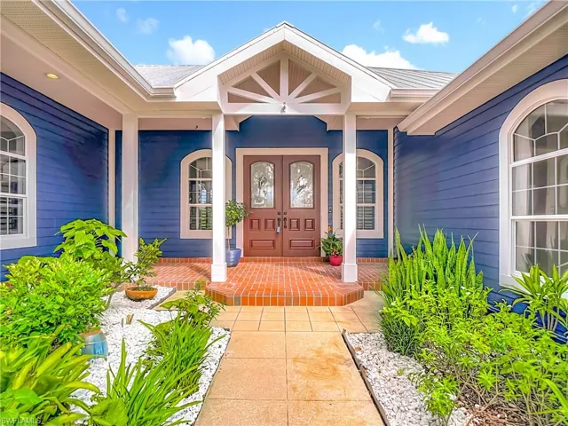 View of exterior entry featuring a porch