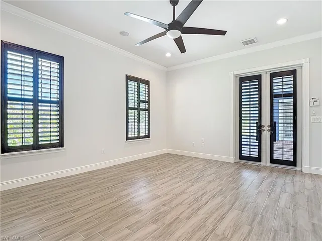 Unfurnished room with french doors, ornamental molding, wood tiled floors, a ceiling fan, and recessed lighting