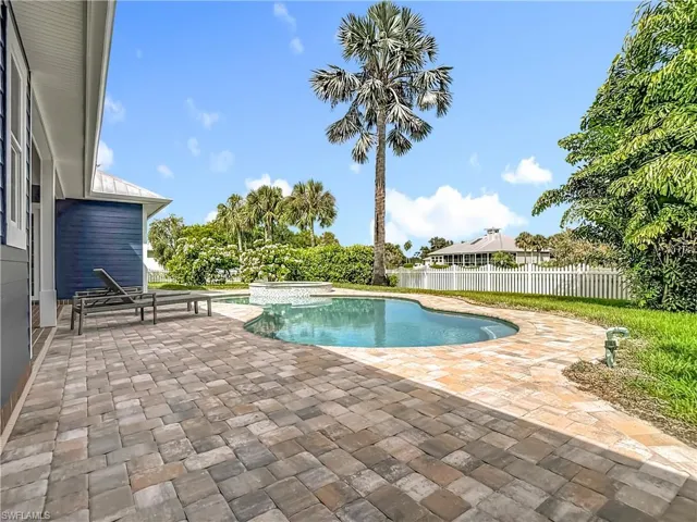 View of swimming pool with a patio and a pool with connected hot tub
