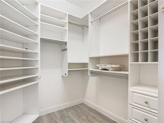 Spacious closet with wood finish floors