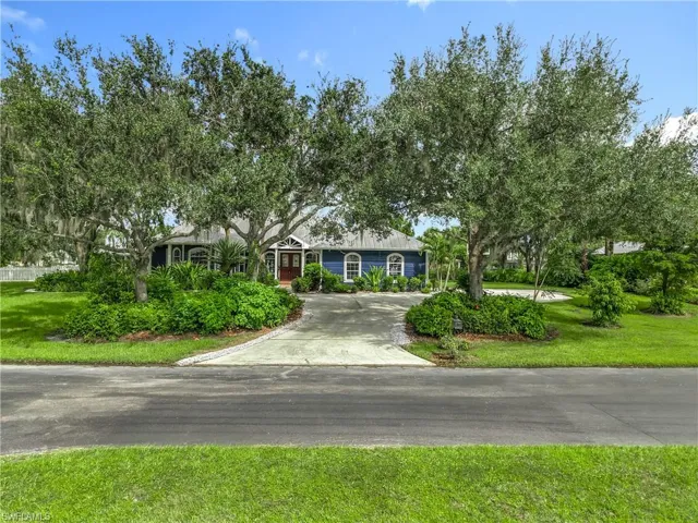 View of front of home with a front lawn and driveway