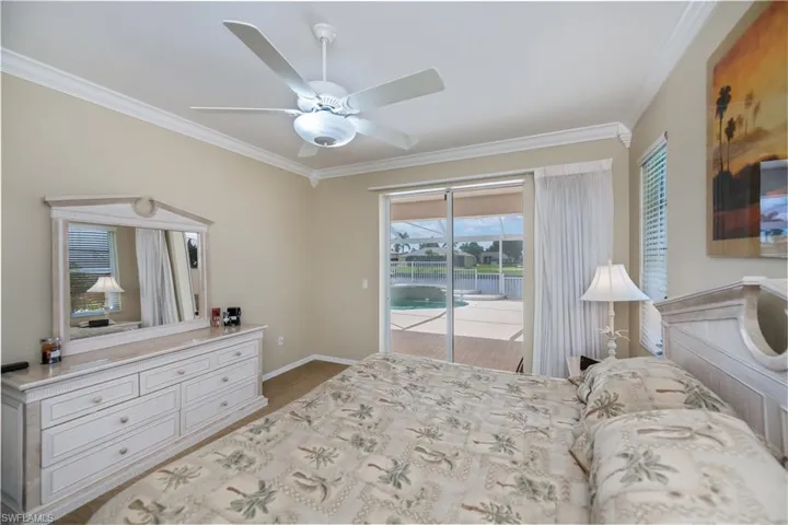 master bedroom looking out to the lanai and pool area and wide water view