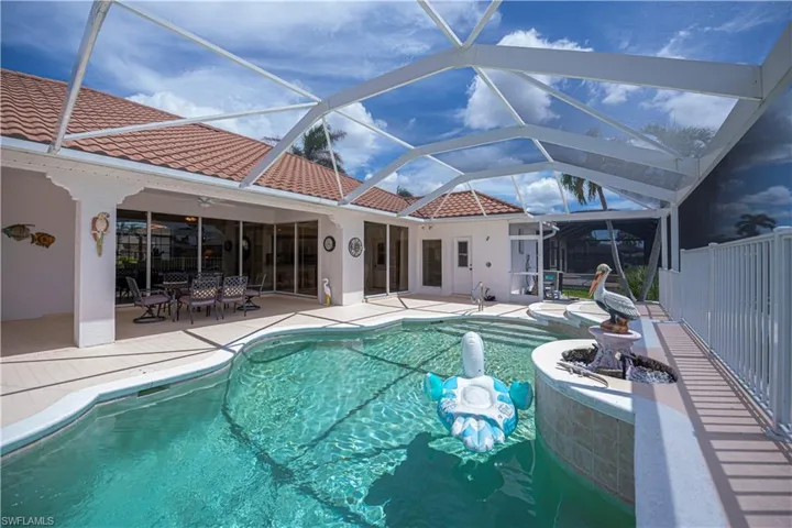 pool looking into the under covered lanai area and house
