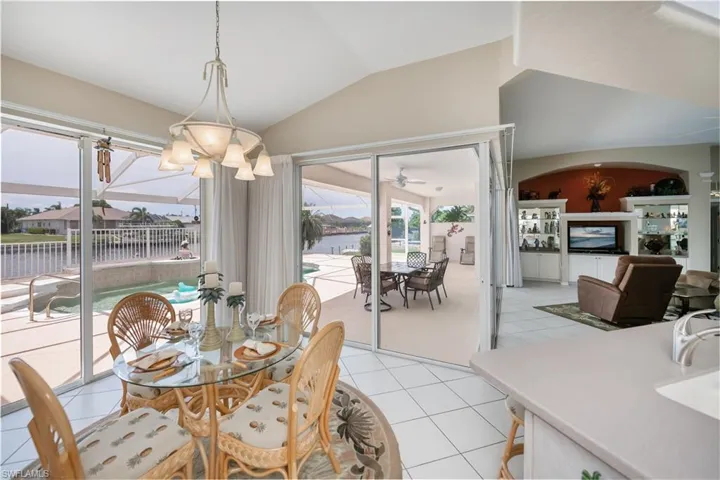 eat in kitchen area looking out to pool/lanai/ and great room and beautiful view of the wide canal and pool area