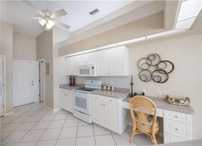 kitchen with built in desk area and looking towards garage door and laundry room entrance