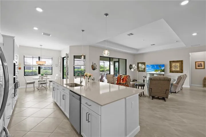 Kitchen featuring pendant lighting, recessed lighting, stainless steel dishwasher, visible vents, and a sink