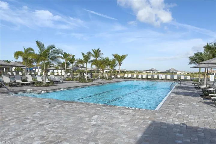 Community pool with a patio