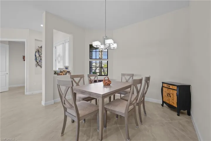Dining area featuring an inviting chandelier and baseboards