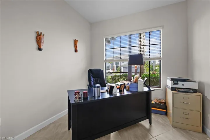 Home office or fourth bedroom with baseboards and light tile patterned floors