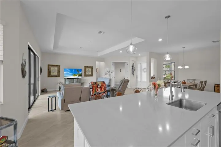 Kitchen with a sink, white cabinetry, visible vents, light countertops, and recessed lighting