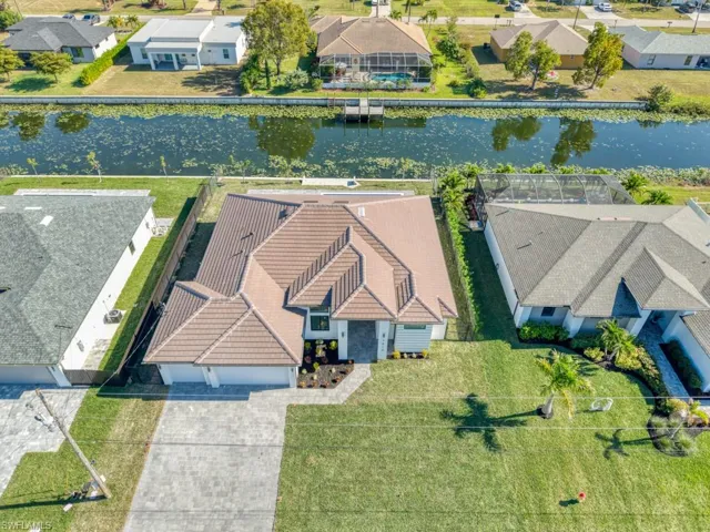Aerial perspective of suburban area with a nearby body of water