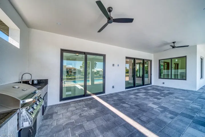 View of patio featuring grilling area and ceiling fan