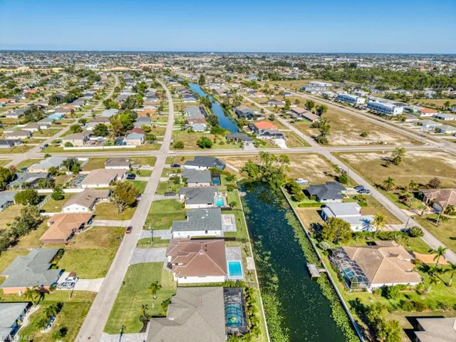 Aerial overview of property's location featuring nearby suburban area and a nearby body of water