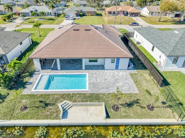 Aerial perspective of suburban area featuring a pool area