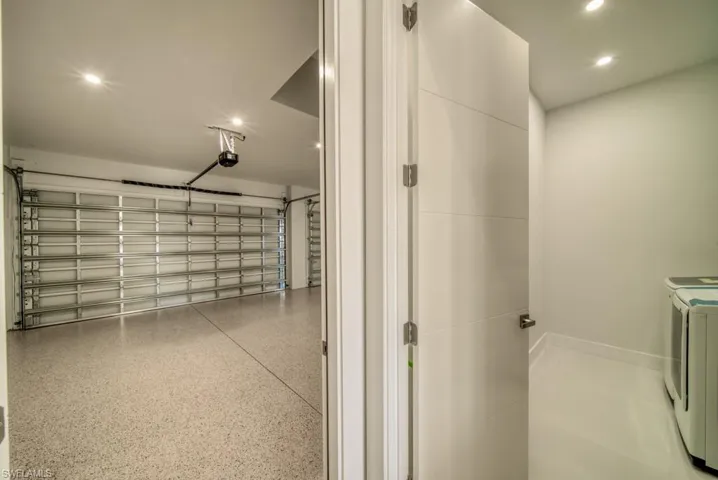 Garage featuring separate washer and dryer and recessed lighting
