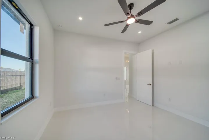Empty room with recessed lighting and a ceiling fan