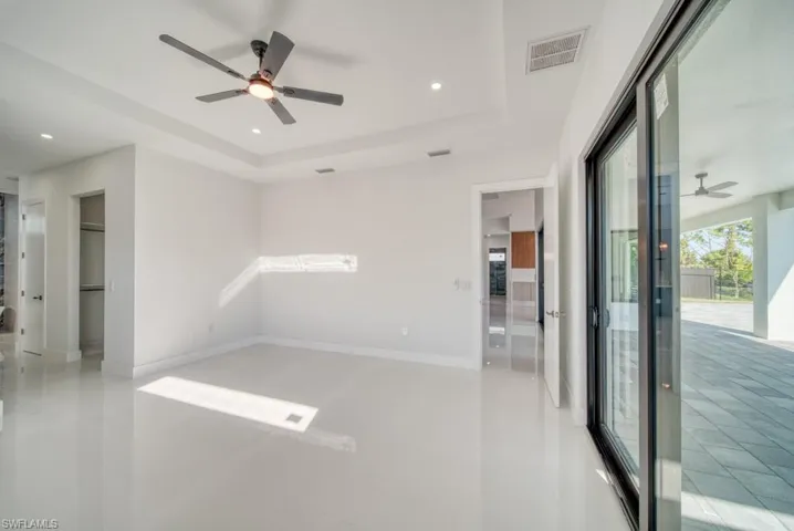 Unfurnished room featuring ceiling fan, a tray ceiling, and recessed lighting