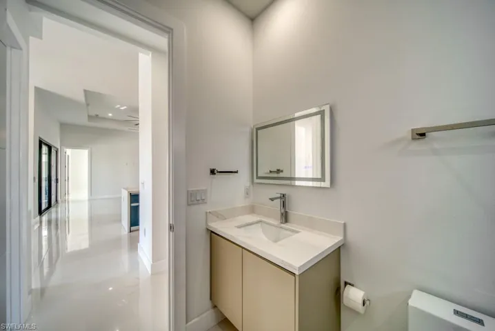 Half bath featuring vanity and recessed lighting