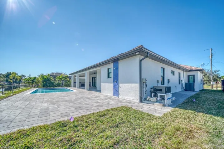 Rear view of property featuring a patio and stucco siding