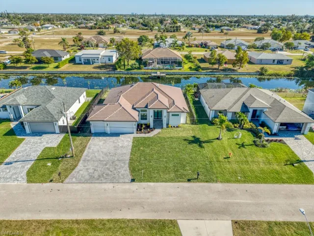 Aerial perspective of suburban area featuring a nearby body of water