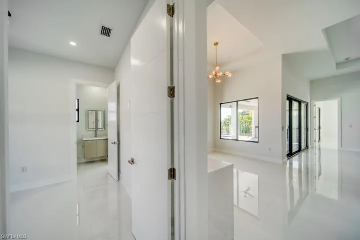 Corridor with a chandelier and baseboards