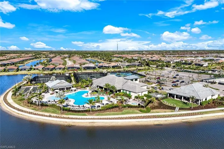 Expansive community grounds featuring a large swimming pool, multiple tennis courts, and several permanent structures