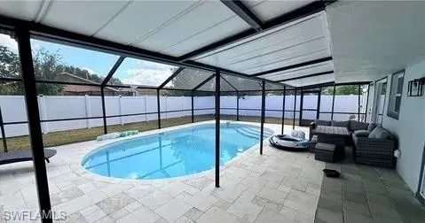 Screened pool enclosure with a light-colored paver deck