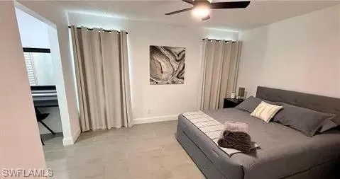 Recessed lighting, ceiling fan, tile flooring, and integrated built-in desk area